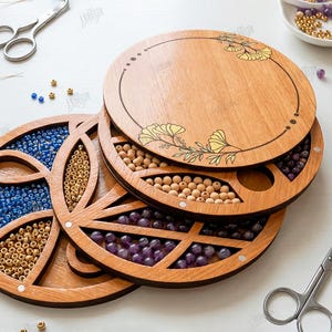May include: Wooden bead organizers with floral designs and compartments filled with beads in various colors. The organizers are round and stacked, with scissors and other craft supplies nearby. The image also includes the text "CUT READY FILE" and file type abbreviations.