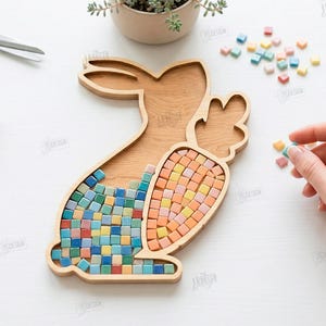 May include: Wooden bunny-shaped tray with a carrot-shaped section, filled with colorful mosaic tiles. The tray is surrounded by craft supplies and small plants. The image also includes the text "CUT READY FILE DIGITAL DOWNLOAD".