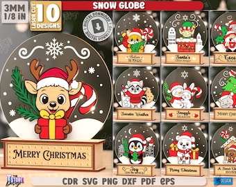 May include: A collection of laser-cut Christmas snow globe designs. The main globe features a reindeer with a candy cane and a gift. Other designs include a fox, elf, gnome, raccoon, snowman, bunny, penguin, bear, and dog. The base reads "Merry Christmas".