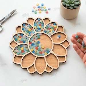 May include: A wooden sunflower-shaped craft project with a mosaic tile design. The project is partially filled with colorful square tiles. Scissors, glue, and a small succulent plant are also visible. The text "CUT READY FILE DIGITAL DOWNLOAD" is on the right.