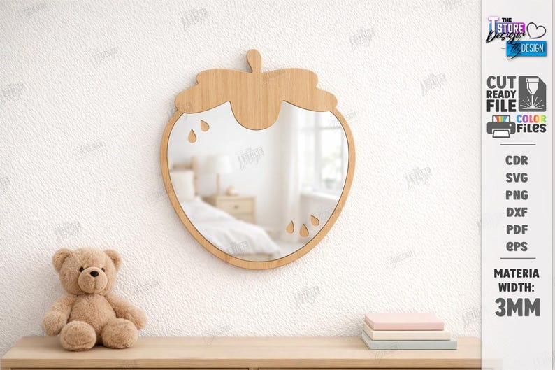 May include: A wooden strawberry-shaped mirror with a natural finish hangs on a white wall. The mirror has a clear reflective surface and teardrop cutouts. A teddy bear and stacked books sit below. The material width is 3mm.