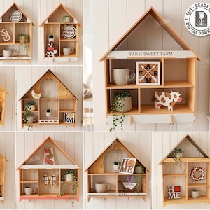 May include: A selection of ten wooden house-shaped shelves, each with a unique design. Some shelves feature decorative items like small plants, mugs, and signs with phrases like "Farm Sweet Farm" and "Home". The shelves are made of light-coloured wood.