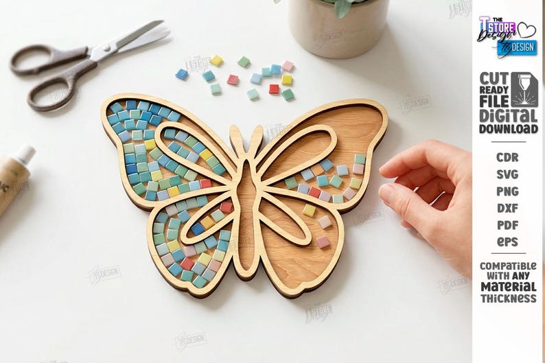 May include: A wooden butterfly-shaped tray with a mosaic tile design. The mosaic tiles are in shades of blue, green, yellow, and red. The tray is surrounded by scattered tiles, scissors, and a tube of glue. The image also includes the text "CUT READY FILE DIGITAL DOWNLOAD".