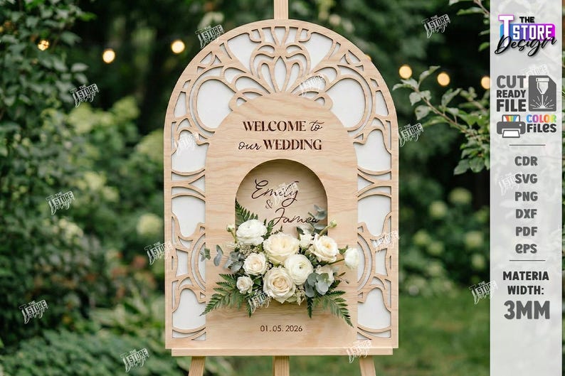 May include: A wooden wedding welcome sign with an arched top and floral accents. The sign reads "Welcome to our Wedding" and features the names "Emily & James" and the date "01.05.2026". The sign is supported by a wooden easel.