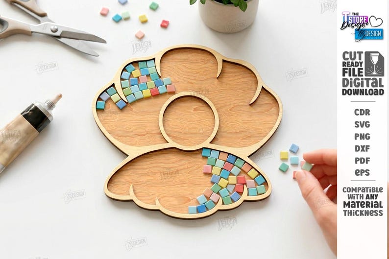 May include: A wooden craft tray with a flower-like design, partially filled with colorful mosaic tiles. Scissors and a tube of adhesive are nearby. The image also includes text that says "CUT READY FILE DIGITAL DOWNLOAD".