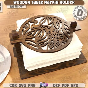 May include: Wooden table napkin holder with a laser-cut peacock design. The dark brown holder is 3mm (1/8 in) thick and holds a stack of white napkins. The text "WOODEN TABLE NAPKIN HOLDER" is visible.