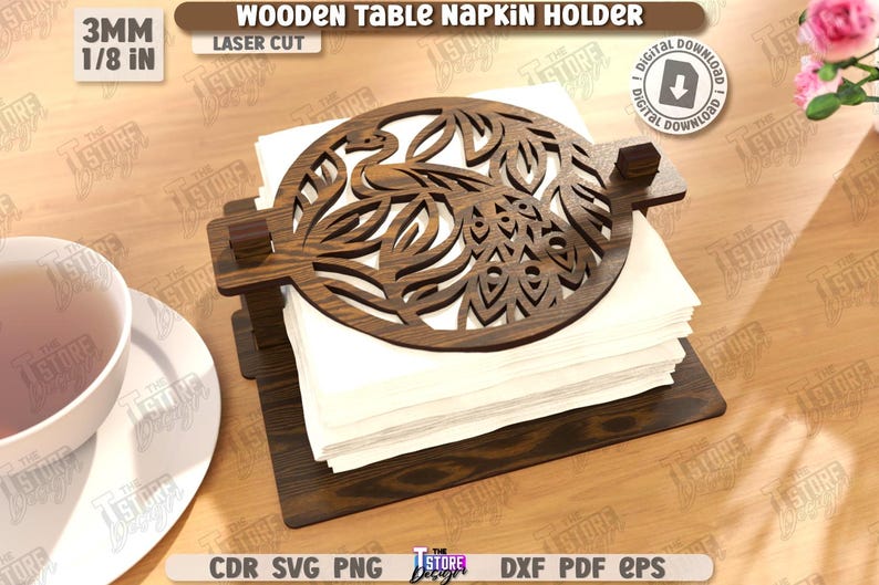 May include: Wooden table napkin holder with a laser-cut peacock design. The dark brown holder is 3mm (1/8 in) thick and holds a stack of white napkins. The text "WOODEN TABLE NAPKIN HOLDER" is visible.