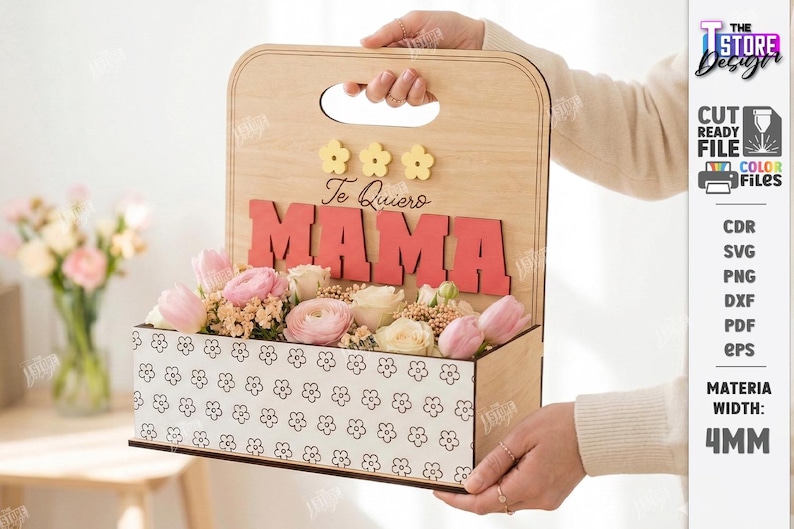 May include: Wooden flower box with the word "MAMA" in red letters and the phrase "Te Quiero" above. The box is filled with pink and white flowers. The box has a handle and a floral pattern.