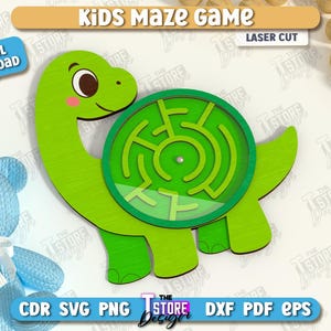 May include: A green wooden dinosaur-shaped maze game for kids. The maze is circular and has a clear cover. The text "Kids Maze Game" and "Laser Cut" are at the top. A blue teddy bear is in the background. Digital download available.