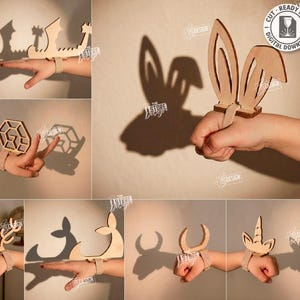 Può includere: Una collezione di dieci marionette a mano in legno tagliate al laser progettate per proiettare ombre su una parete. Ogni forma in legno chiaro è dotata di un cinturino per il fissaggio alla mano. Il set include disegni come orecchie di coniglio e cervo.
