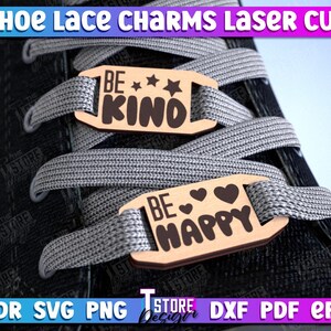 May include: Two wooden shoe lace charms with the text "Be Kind" and "Be Happy" on them. The charms are attached to a pair of shoelaces on a black shoe.