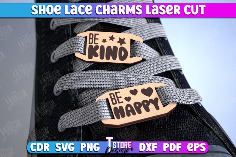 May include: Two wooden shoe lace charms with the text "Be Kind" and "Be Happy" on them. The charms are attached to a pair of shoelaces on a black shoe.