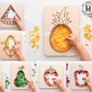 Puede incluir: Una colección de diez tablas de madera cortadas con láser que presentan contornos de frutas y verduras, incluyendo una piña, zanahoria, sandía y manzana. Cada tabla tiene un centro hueco relleno con pequeños trozos de papel de colores.