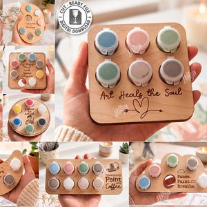 Könnte beinhalten: Ein quadratischer Holzhalter für eine Farbpalette mit sechs kreisförmigen Aussparungen für kleine Farbtöpfe. Das Holz ist mit dem Text Art Heals the Soul und einem Herzsymbol graviert. Digitale Datei für Laserschnitt, 10 Designs.