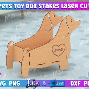 May include: Laser cut wooden dog toy box with a heart-shaped cutout for personalization. The box is designed to hold pet toys and has a 3mm (1/8 inch) thickness.