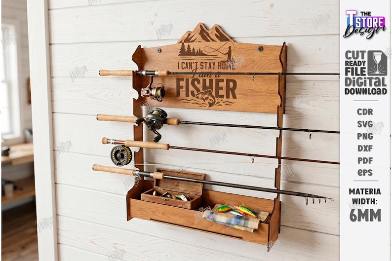 May include: Wooden fishing rod rack with the text "I CAN'T STAY HOME I AM A FISHER". The rack has a mountain and fishing scene design. It holds four fishing rods, a tackle box, and fishing lures. The rack is mounted on a white wooden wall.