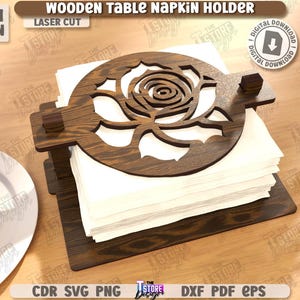 May include: Wooden table napkin holder with a laser-cut rose design. The dark brown holder is made of wood and holds a stack of white napkins. The text "WOODEN TABLE NAPKIN HOLDER" is visible.