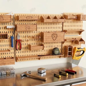 May include: A wooden pegboard with various tool storage and organization features. Includes shelves, boxes, and tool holders. The pegboard has a light brown color and is designed for workshop or garage use. The image also includes tools like a hammer, screwdrivers, and a saw.
