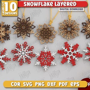 May include: Ten laser-cut snowflake designs in various styles and colors, including brown, red, and white. Each snowflake is suspended by a gold string. The image includes the text "SNOWFLAKE LAYERED DIGITAL DOWNLOAD".