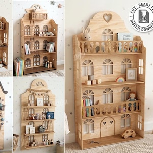 Peut inclure: Étagère en bois en forme de maison de poupée avec plusieurs étagères et fenêtres cintrées. La conception comprend un balcon et des découpes en forme de cœur. Le texte "CUT READY FILE DIGITAL DOWNLOAD" et "5 DESIGNS" est également visible.