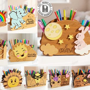 May include: A set of ten wooden desk tidies, each featuring a different design. Themes include a rainbow, an elephant, a moon and stars, a rabbit, and a smiling sun. Each organiser is designed to hold pens and pencils.