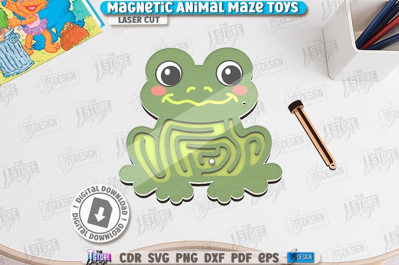 May include: A green frog-shaped magnetic maze toy with a yellow maze path. The toy has a wooden wand for moving a magnetic ball through the maze. The text "MAGNETIC ANIMAL MAZE TOYS" and "LASER CUT" are visible.