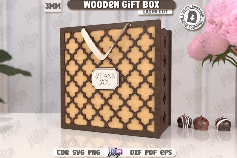 May include: A laser-cut wooden gift box with a decorative geometric pattern. The box is brown with a light-colored interior and a white handle. A small label reads "Thank You". The image also includes the text "Wooden Gift Box" and "Digital Download".