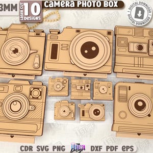 May include: A collection of ten laser-cut camera designs made from 3mm thick material. The designs include various camera styles, with detailed lens and body features. The text "Camera PHOTO BOX" and "10 DESIGNS" are visible. The image also includes the text "DIGITAL DOWNLOAD".