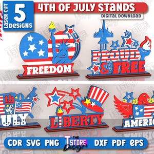 May include: A collection of five laser-cut 4th of July stand designs. Each design features patriotic themes in red, white, and blue, including the Statue of Liberty, an eagle, and the words "Freedom", "Proud & Free", "Liberty", and "America". The stands are 3mm thick.