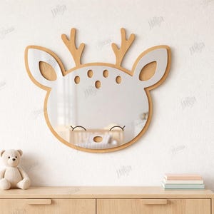 May include: A deer-shaped mirror with a wooden frame and antlers, designed for wall mounting. The mirror has a white face with brown accents and is displayed on a white wall. The text on the right says "CUT READY FILE" and "MATERIAL WIDTH: 3MM".