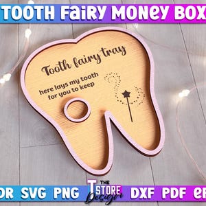 May include: A pink tooth-shaped wooden box with the text "Tooth fairy tray" and "here lays my tooth for you to keep".