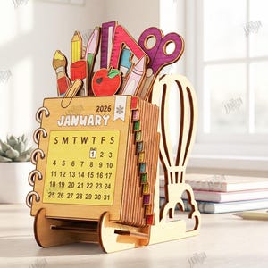 May include: Wooden desk organizer and calendar for 2026. The organizer features a calendar for January, with a pen holder and slots for stationery. Includes a pencil, scissors, ruler, and an apple. The material width is 3mm.