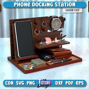 Op de afbeelding: Een houten telefoon laadstation met een telefoonhouder, een horlogehouder, een brillenhouder en een compartiment voor andere items. Het station is gemaakt van 6 mm (1/4 inch) dik hout en is lasergesneden.