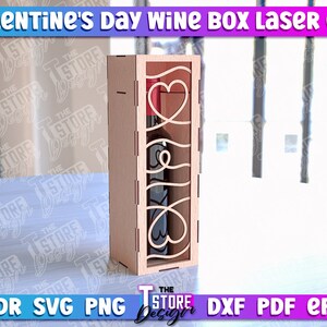 May include: Laser cut wine box with a heart design. The box is made of wood and is designed to hold a standard-sized wine bottle. The box is perfect for a Valentine's Day gift.