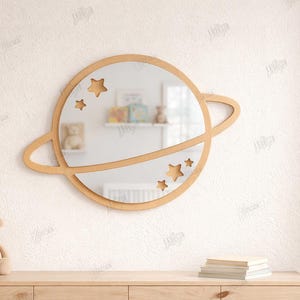 May include: A wooden planet-shaped mirror with star cutouts, ideal for a nursery or children's room. The mirror is surrounded by a light brown frame and has a diameter of approximately 12 inches. The image also shows a teddy bear and books.