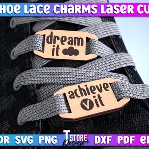 May include: Two wooden shoe lace charms with inspirational messages. The top charm reads "dream it" with a cloud icon. The bottom charm reads "achieve it" with a checkmark icon.