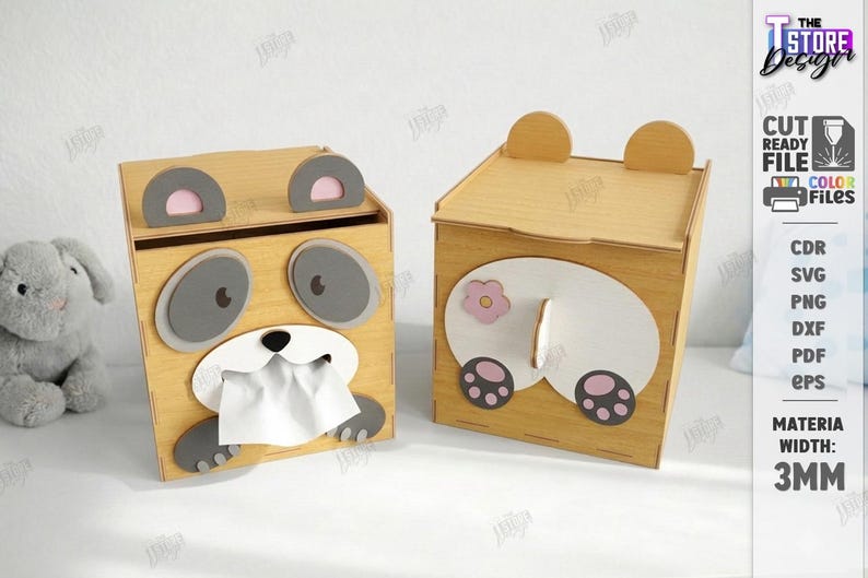 May include: Two wooden tissue box holders, one with a panda face design and the other with a bear butt design. The panda box has gray eyes and paws, with tissue paper coming out of its mouth. The bear box has a pink flower and paw prints.