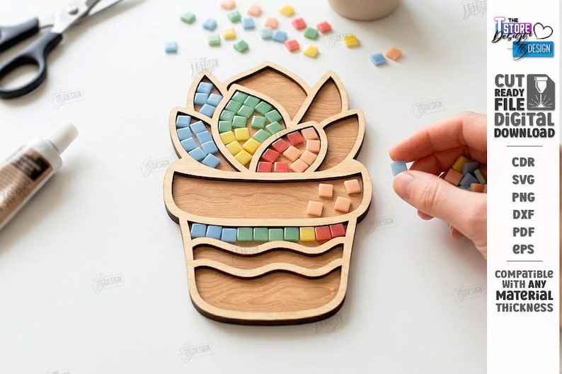 May include: Wooden succulent-shaped mosaic tile holder with colorful square tiles. The holder is made of light-colored wood and has sections for the tiles. The image also shows a tube of glue and scissors.
