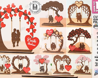 May include: A collection of laser-cut wooden designs featuring couples on swings, trees, and heart-shaped frames. Each design includes a heart with a name. The designs are suitable for weddings or anniversaries.