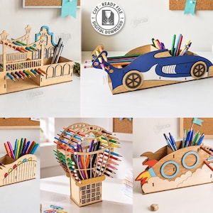 May include: A collection of five laser-cut wooden desk organizers featuring designs of a building, a race car, a Ferris wheel, a hot air balloon, and a rocket ship. Each organizer has slots for pens and pencils, with a material width of 3mm.
