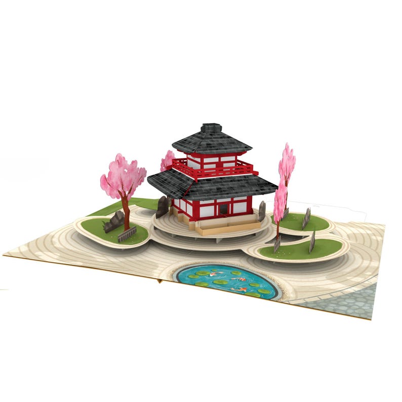 May include: A pop-up card depicting a Japanese pagoda with a red and black roof, set in a garden with pink cherry blossom trees and a pond with koi carp. The card is on a light beige background.
