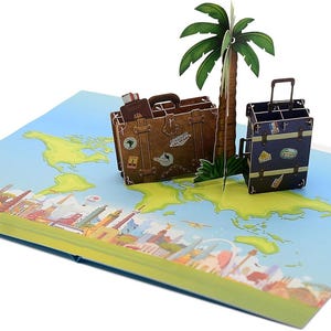 May include: A pop-up greeting card featuring a world map with a palm tree and two suitcases. The suitcases are brown and blue with travel stickers. The card has a blue background with a cityscape at the bottom.