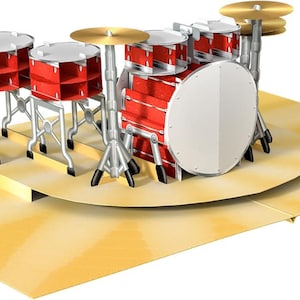 May include: A pop-up greeting card depicting a red drum kit with silver stands and gold cymbals. The drum kit sits on a yellow stage with a sunburst pattern. The card is open and ready to be displayed.