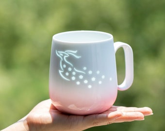 Everyday porcelain mug with delicate, translucent design and hand engraved by the underglaze artist
