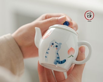 Porcelain teapot and handmade craft with cute happy cat design