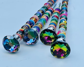 May include: Four decorative metal sticks with colorful beads and iridescent crystal tops. The beads are a mix of colors, including red, blue, green, yellow, and orange.