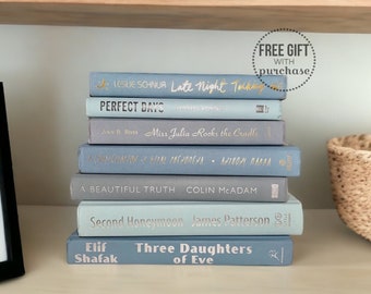 May include: A stack of blue and gray paperback books with gold lettering on a white shelf. The titles include "Late Night Talking", "Perfect Days", "Miss Julia Rocks the Cradle", "A Concoction of Vital Ingredients", "A Beautiful Truth", "Second Honeymoon", "Three Daughters of Eve".