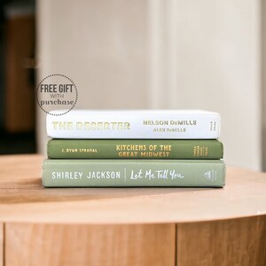 May include: A stack of three hardcover books with green and white covers. The top book is titled "The Deserter" by Nelson DeMille and Alex DeMille. The middle book is titled "Kitchens of the Great Midwest" by J. Ryan Stradel. The bottom book is titled "Let Me Tell You" by Shirley Jackson.