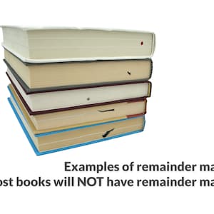 May include: A stack of six books with different colored covers. The top book is white, the second is beige, the third is gray, the fourth is white, the fifth is maroon, and the bottom book is blue. The books have black marks on the edges of the pages, which are called remainder marks.  Examples of remainder marks. Most books will NOT have remainder marks.