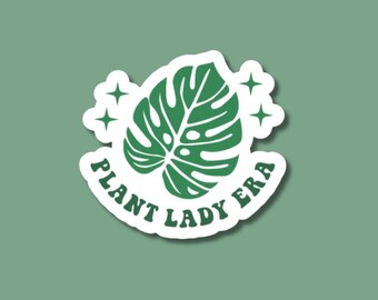 May include: White sticker with a green monstera leaf, two white stars, and the text "Plant Lady Era".